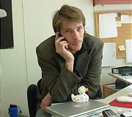 Ola Lindholm talar i telefon vid sitt skrivbord